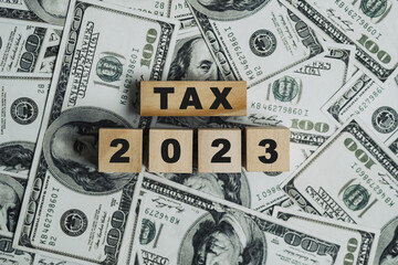 2023 tax concept, paying taxes, 2023, paying tax rates, collecting taxes, tax burden icon on wooden...