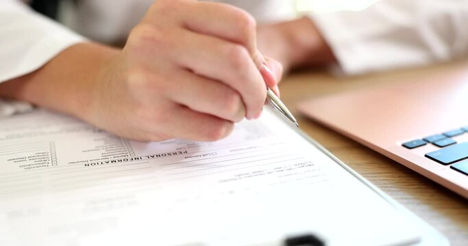 Doctor makes notes on medical records closeup