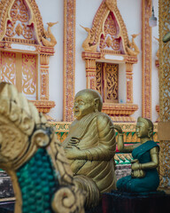 Fototapeta premium a golden statue of a happy Buddha in Vat Sisoumang