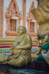 Fototapeta premium a golden statue of a happy Buddha in Vat Sisoumang