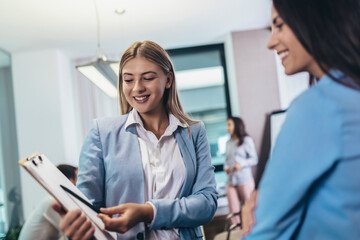 Fototapeta premium Two businesswomen talking in the office