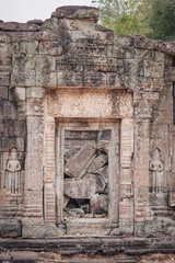 Fototapeta premium Siem Reap, Cambodia - March 19th, 2020 : door of a ruin temple at Angkor Wat archeological complex
