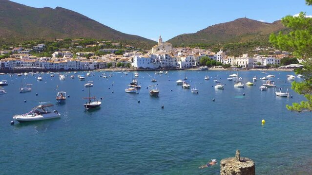 Coastal village full of small boats docked at sea on a sunny summer day, Cadaques, Girona Catalonia.