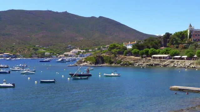 Nice coastline with docked boats and small buildings in a Mediterranean landscape in Girona, Spain.