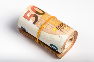 Roll of money. Roll of 50 euro banknotes. Euro banknotes rolled up on a gray background. The concept of financial assistance, real estate purchase, loan or insurance payment.