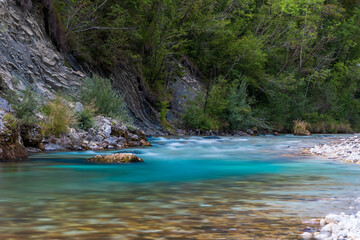 Colorful long exposure picture of emerald Soa (also known as Isonzo) River Valley at Julian Alps in Bovec, Slovenia