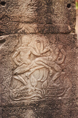 Siem Reap, Cambodi - March 19th, 2020 : buddhists figures carved in the stone walls of a temple at Angkor Wat archeological complex