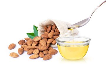 Almond oil and almond nuts in hemp sack bag with green leaf isolated on white background.