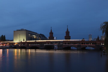 view of the city river and subway at night