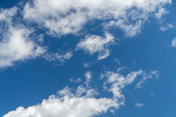 Naklejka na ściany i meble Deep blue sky with white clouds as a pattern, texture, background