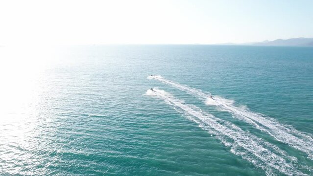 Aerial footage of people on hydrocycles ride in the open water