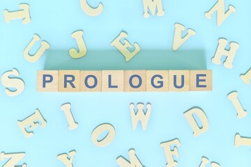 Prologue part of a book concept. Wooden blocks typography word flat lay in blue background
