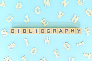 Bibliography part of a book concept. Wooden blocks typography word flat lay in blue background