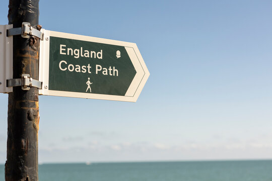 close up england coast path sign on a kentish shingle beach, copy space