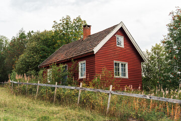 a red house by a field