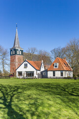 Fototapeta na wymiar Historic church and white houses in Frisian village Makkum, Netherlands