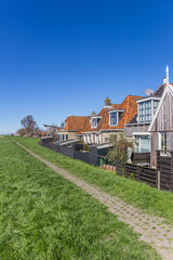 Historic houses behind the dike in Frisian village Makkum, Netherlands