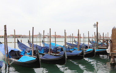 Fototapeta na wymiar Gondolas the typical tourist boats of Venice - Italy without people during the lockdown