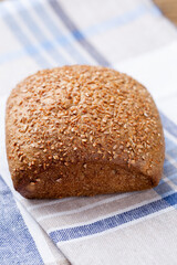 Gold rustic crusty loaves of bread and buns on wooden background. Still life captured from above top view, flat lay.