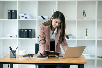 Asian businesswoman chatting with customers via laptop online