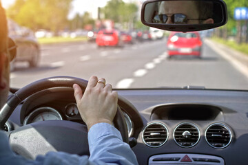 Naklejka premium Driving a car through the streets of the city