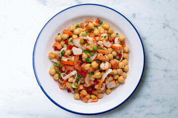 Chickpea salad with crab and vegetables. Cold salad typical Spanish cuisine.