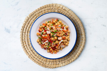 Chickpea salad with crab and vegetables. Cold salad typical Spanish cuisine.