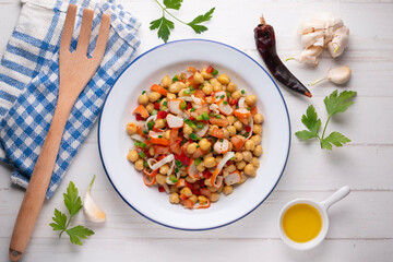 Chickpea salad with crab and vegetables. Cold salad typical Spanish cuisine.