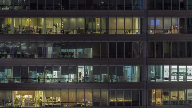 Windows of office buildings at night timelapse, the light from the windows of houses