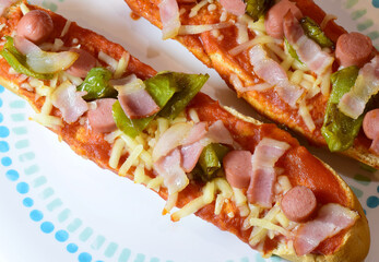 Zenith view, pizza bread, with mozzarella, tomato sauce, frankfurt, beacon and strips of green pepper