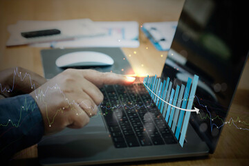 Businessman using laptop with analyzing forex trading graph financial data. business finance technology and investment concept. Stock Market Investments funds Business finance background.