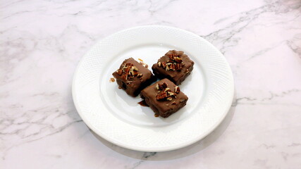 Three pieces of cake with walnut garnish