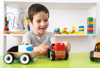 Shot of a child playing with miniature toy cars