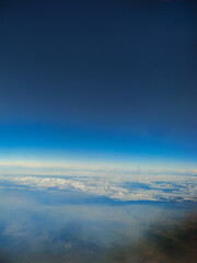 Flying between clouds and blue sky at high altitude	

