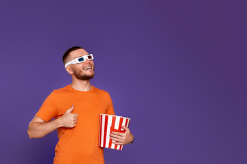 man eating popcorn and showing ok gesture