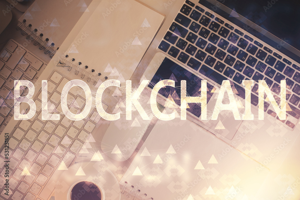 Poster Blockchain theme hologram drawings over computer on the desktop background. Top view. Double exposure.