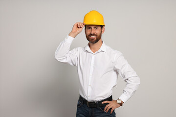 Professional engineer in hard hat on white background