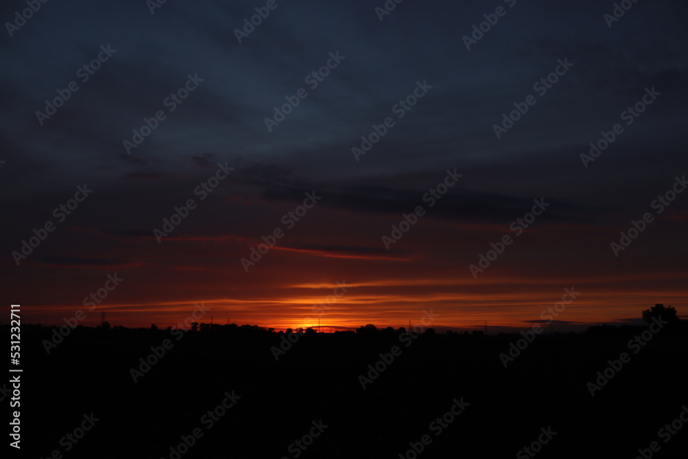 Wall mural Beautiful sunset with orange and yellow clouds