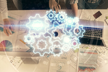 Double exposure of man and woman working together and financial theme hologram. international business concept. Computer background.