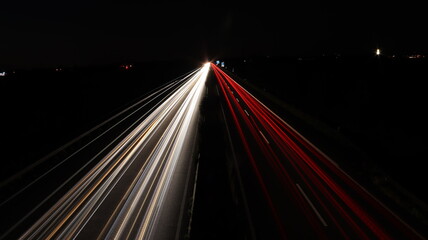 Fototapeta na wymiar Red and white car light stripes on a street