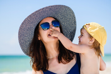 Mom and daughter at beach chaise lounge