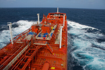 A merchant ship is underway at sea, view from the bridge wings