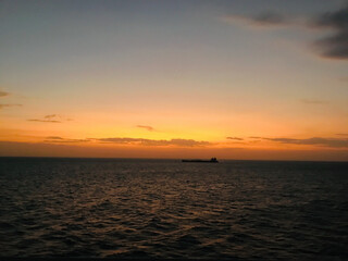 Obraz premium View from the bridge wings of a ship at sea in the evening