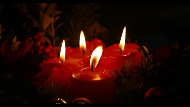 burning candles in the dark. Christmas candles. Light. Gift. Red candle. Figure. Decor. 