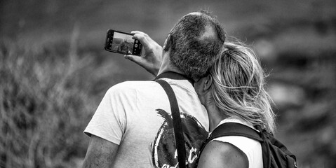 Couple taking selfie in a national park, back view