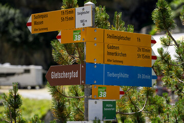 Sign post at hiking trail at Swiss mountain pass Susten on a sunny summer day. Photo taken July 13th, 2022, Susten Pass, Switzerland.