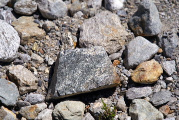 Close-up of stones on the ground at Swiss mountain Pass Susten on a sunny summer day. Photo taken July 13th, 2022, Susten Pass, Switzerland.