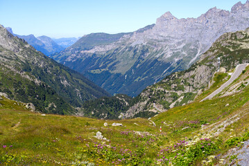 Fototapeta na wymiar Beautiful scenic view of mountain panorama with mountain pass road at Swiss mountain pass Sustenpass on a sunny summer day. Photo taken July 13th, 2022, Susten Pass, Switzerland.