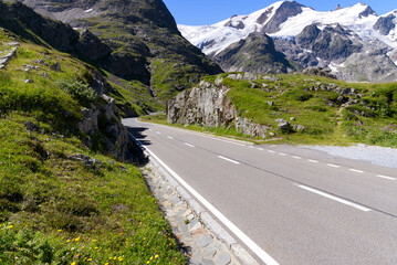 Naklejka premium Beautiful aerial view over Gadmer Valley, Canton Bern, with road at Swiss mountain pass Sustenpass on a sunny summer day. Photo taken July 13th, 2022, Susten Pass, Switzerland.