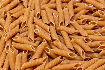 Background from pasta. Penne, Penne Rigate.